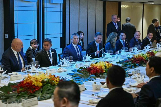 US Secretary of Defence Pete Hegseth (C), Thailand's Defence Minister Adul Boonthamcharoen (centre, L), and Singapore's Minister of Defence Chan Chun Sing (centre, R) attend a ministerial roundtable during the 23rd Shangri-La Dialogue summit in Singapore on May 30, 2026. (Photo by MOHD RASFAN / AFP)