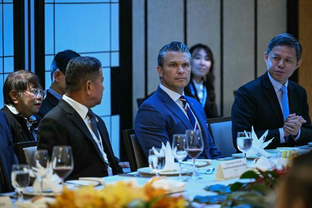 US Secretary of Defence Pete Hegseth (C), Thailand's Defence Minister Adul Boonthamcharoen (L), and Singapore's Minister of Defence Chan Chun Sing attend a ministerial roundtable during the 23rd Shangri-La Dialogue summit in Singapore on May 30, 2026. (Photo by MOHD RASFAN / AFP)