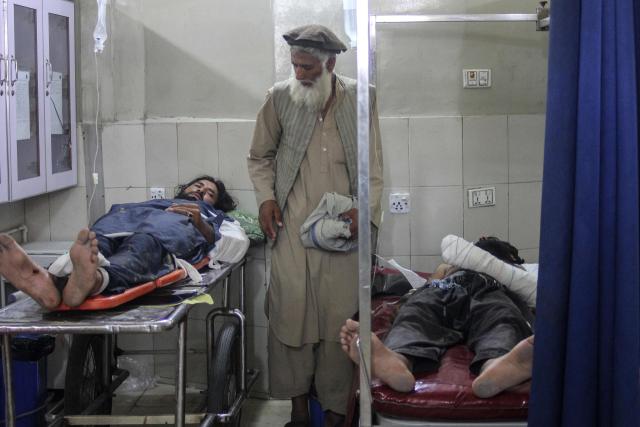 Injured people receive treatment at a hospital after a truck carrying Afghan families overturned, in Jalalabad on May 30, 2026. A truck overturned in eastern Afghanistan on May 30, killing 18 people on board including 10 children, a provincial official told AFP. (Photo by Aimal Zahir / AFP)