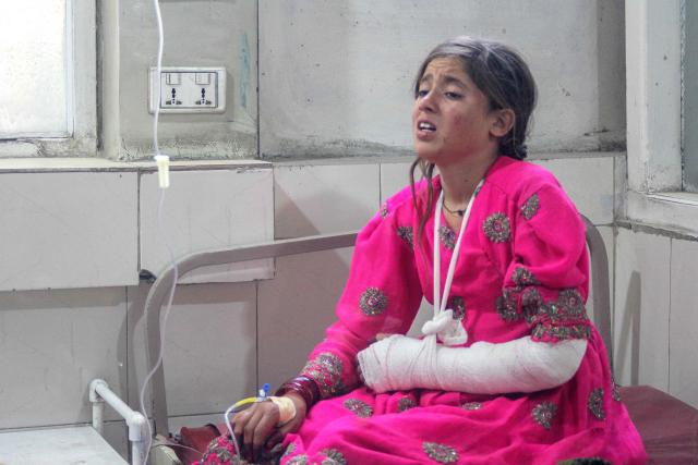 An injured girl receives treatment at a hospital after a truck carrying Afghan families overturned, in Jalalabad on May 30, 2026. A truck overturned in eastern Afghanistan on May 30, killing 18 people on board including 10 children, a provincial official told AFP. (Photo by Aimal Zahir / AFP)