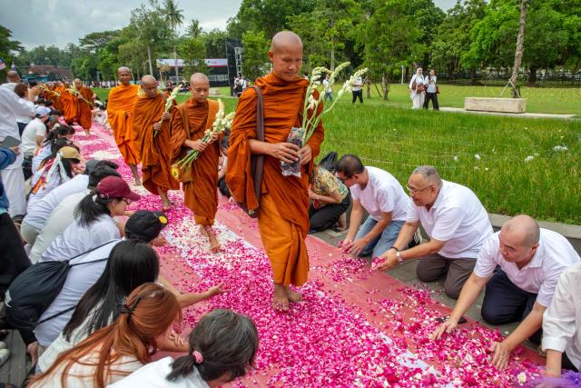 Multinational Buddhist monks walk on flower petals as they arrive at Borobudur Temple, a 9th-century Buddhist monument and UNESCO World Heritage Site, in Magelang, Central Java, on May 30, 2026, as part of the Indonesia Walk of Peace (IWOP 2026), a 660-kilometre journey from Bali completed over 20 days ahead of the Vesak Day celebration. (Photo by DEVI RAHMAN / AFP)