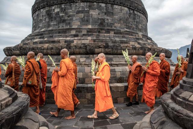 Multinational Buddhist monks perform a ritual around the main stupa at Borobudur Temple, a 9th-century Buddhist monument and UNESCO World Heritage Site, in Magelang, Central Java, on May 30, 2026, as part of the Indonesia Walk of Peace (IWOP 2026), a 660-kilometre journey from Bali completed over 20 days ahead of the Vesak Day celebration. (Photo by DEVI RAHMAN / AFP)