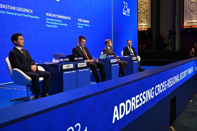 (L-R) South Korea's Minister of National Defense Ahn Gyu-back (L), Director General and Chief Executive of the International Institute for Strategic Studies (IISS) Bastian Giegerich, Secretary-General of the Shanghai Cooperation Organisation Nurlan Yermekbayev, and Norway's Defence Minister Tore Sandvik take part in the fourth plenary session of the 23rd Shangri-La Dialogue summit in Singapore on May 30, 2026. (Photo by JAM STA ROSA / AFP)