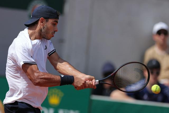 Argentina's Francisco Cerundolo plays a backhand return to US Zachary Svajda during their men's singles match on day 7 of the French Open tennis tournament at the Roland-Garros Complex in Paris on May 30, 2026. (Photo by Thomas SAMSON / AFP)