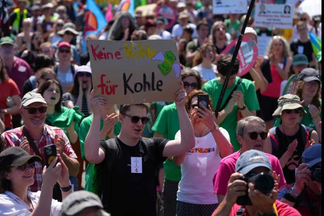 A man hols a placard reading 'No money for coal' as he take part in a demonstration under the motto "Future instead of gas – Together for the energy transition" organized by environmental organizations BUND, Campact, Fridays For Future, and Greenpeace against the German government's energy policy, on May 30, 2026 in Hamm, western Germany. (Photo by Pau BARRENA / AFP)