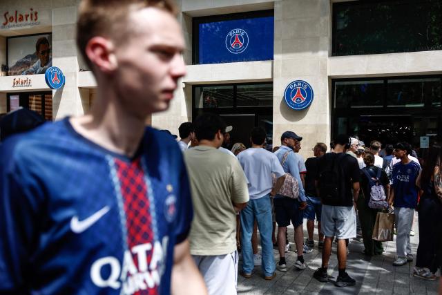 Shoppers queue outside the Paris Saint on the Champs-Elysees avenue in Paris, on May 30, 2026 ahead of the UEFA Champions League Final football match between Paris Saint-Germain (PSG) and Arsenal FC taking place in Budapest. Twenty-two thousand police officers and gendarmes, including 8,000 have been mobilised for Paris and its surrounding area. French police have put in place an unprecedented security operationto prevent any potential damage or violence on May 30, ahead of PSGs Champions League final against Arsenal. (Photo by Kenzo TRIBOUILLARD / AFP)