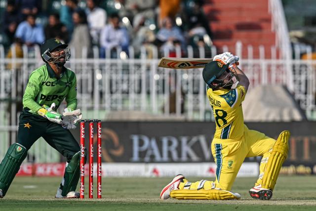 Australia's captain Josh Inglis (R) watches the ball after playing a shot as Pakistan's wicketkeeper Ghazi Ghori reacts during the first one-day international (ODI) cricket match between Pakistan and Australia at the Rawalpindi Cricket Stadium in Rawalpindi on May 30, 2026. (Photo by Aamir QURESHI / AFP)
