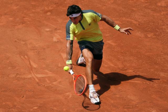 Argentina's Francisco Comesana plays a backhand return to Italy's Matteo Berrettini during their men's singles match on day 7 of the French Open tennis tournament on Court Simonne-Mathieu at the Roland-Garros Complex in Paris on May 30, 2026. (Photo by Dimitar DILKOFF / AFP)