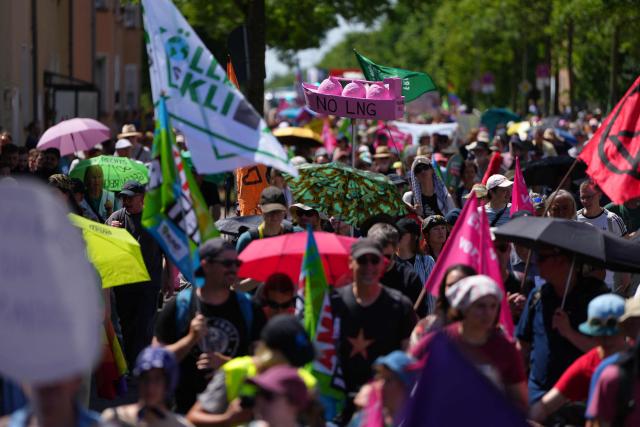 People take part in a demonstration under the motto "Future instead of gas – Together for the energy transition" organized by environmental organizations BUND, Campact, Fridays For Future, and Greenpeace against the German government's energy policy, on May 30, 2026 in Hamm, western Germany. (Photo by Pau BARRENA / AFP)