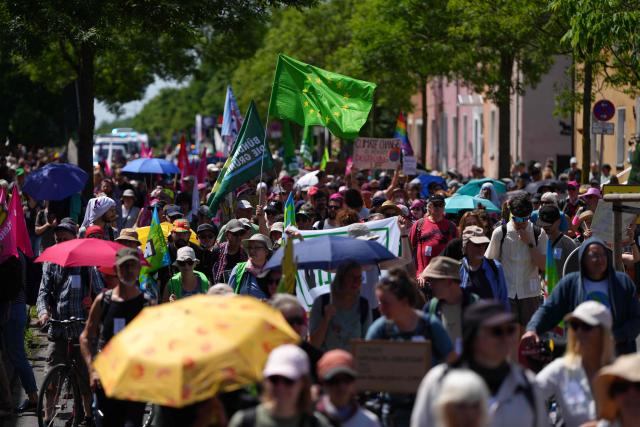 People take part in a demonstration under the motto "Future instead of gas – Together for the energy transition" organized by environmental organizations BUND, Campact, Fridays For Future, and Greenpeace against the German government's energy policy, on May 30, 2026 in Hamm, western Germany. (Photo by Pau BARRENA / AFP)