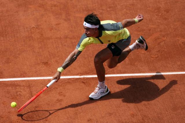 Argentina's Francisco Comesana runs to play a forehand return to Italy's Matteo Berrettini during their men's singles match on day 7 of the French Open tennis tournament on Court Simonne-Mathieu at the Roland-Garros Complex in Paris on May 30, 2026. (Photo by Dimitar DILKOFF / AFP)