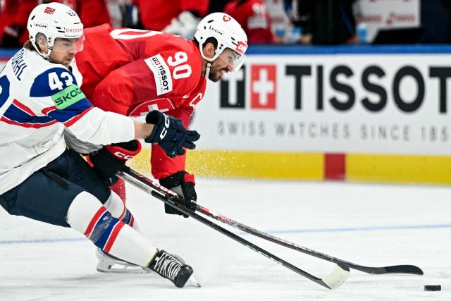 Norway's defender #43 Max Krogdahl (L) vies Switzerland's defender #90 Roman Josi during the IIHF Ice Hockey Men's World Championship semi-final match between Switzerland and Norway at the Swiss Life Arena in Zurich, on May 30, 2026. (Photo by Fabrice COFFRINI / AFP)