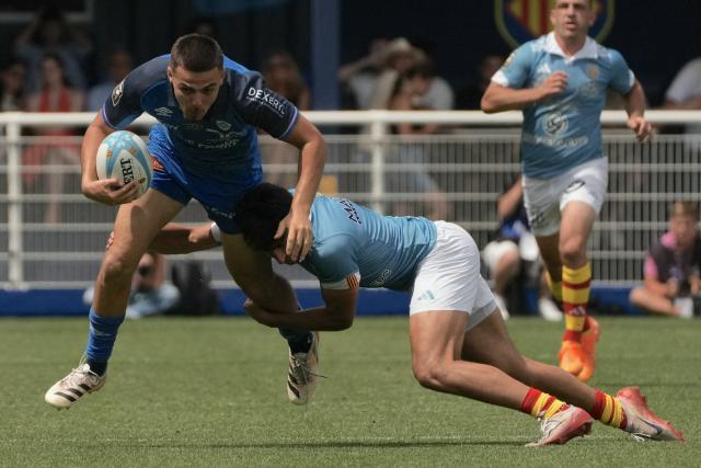 Castres’ French full-back Theo Chabouni is tackled during the French Top14 rugby union match between USA Perpignan and Castres Olympique at the Aime-Giral stadium in Perpignan, south-western France on May 30, 2026. (Photo by Idriss Bigou-Gilles / AFP)