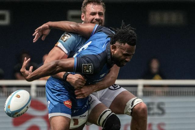Castres’ Fijian centre Vilimoni Botitu is tackled during the French Top14 rugby union match between USA Perpignan and Castres Olympique at the Aime-Giral stadium in Perpignan, south-western France on May 30, 2026. (Photo by Idriss Bigou-Gilles / AFP)