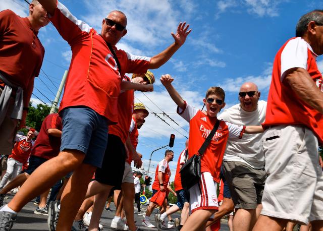 Arsenal supporters cheer as they march towards the stadium in Budapest on May 30, 2026, before the UEFA Champions League final football match to be played between Paris Saint-Germain (PSG) and Arsenal FC in the Hungarian capital. (Photo by Ferenc ISZA / AFP)