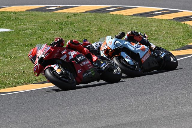 Ducati Lenovo Team's Spanish MotoGP rider Marc Marquez (L) and Trackhouse MotoGP Team's Spanish rider Raul Fernandez take part in the sprint on the eve of the Italian Moto GP Grand Prix at Mugello circuit, in Mugello, near Florence, on May 30, 2026. (Photo by Andreas SOLARO / AFP)