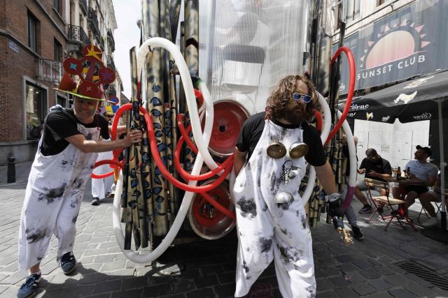 Participants take part in the 14th edition of the 'Zinneke Parade' in Brussels on May 30, 2026. The multicultural carnival and community-led parade weaves through Brussels with towering costumes, street theatre and live music — created in 2000 by artists and neighbourhood collectives, celebrating the city's cultural mix in a joyful, irreverent procession held every two years. (Photo by NICOLAS MAETERLINCK / Belga / AFP) / Belgium OUT