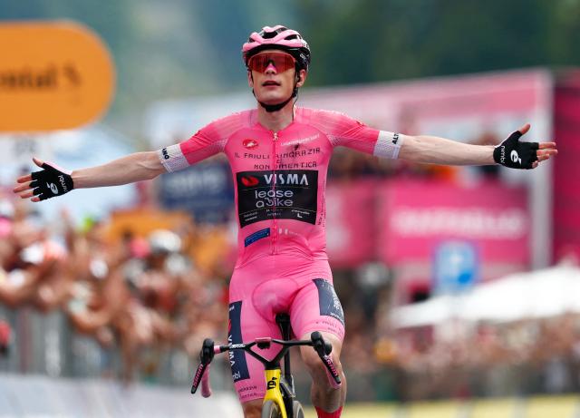 TOPSHOT - Team Visma Lease a Bike Danish rider Jonas Vingegaard wearing the overall leader's pink jersey celebrates as he crossing the finish line to win in the 20th stage of the Giro d'Italia 2026 - Tour of Italy cycling race between Gemona del Friuli and Piancavallo, Italy, on May 30, 2026. (Photo by Luca Bettini / AFP)