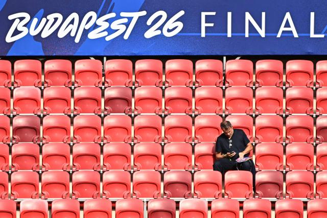 An spectator waits for the start of the UEFA Champions League final football match between Paris Saint-Germain (PSG) and Arsenal FC at the Puskas Arena in Budapest on May 30, 2026. (Photo by Attila KISBENEDEK / AFP)
