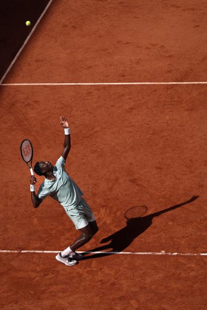 France's Moise Kouame serves to Chile's Alejandro Tabilo during their men's singles match on day 7 of the French Open tennis tournament on Court Suzanne-Lenglen at the Roland-Garros Complex in Paris on May 30, 2026. (Photo by Anne-Christine POUJOULAT / AFP)