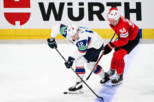 Norway's forward #12 Noah Steen (L) vies Switzerland's forward #94 Attilio Biasca during the IIHF Ice Hockey Men's World Championship semi-final match between Switzerland and Norway at the Swiss Life Arena in Zurich, on May 30, 2026. (Photo by Fabrice COFFRINI / AFP)