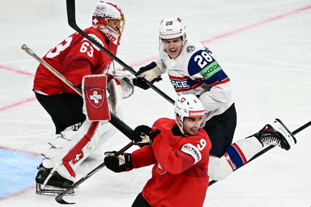 Switzerland's forward #9 Damien Riat (front) and Norway's forward #28 Michael Brandsegg-Nygard (background) react during the IIHF Ice Hockey Men's World Championship semi-final match between Switzerland and Norway at the Swiss Life Arena in Zurich, on May 30, 2026. (Photo by Fabrice COFFRINI / AFP)