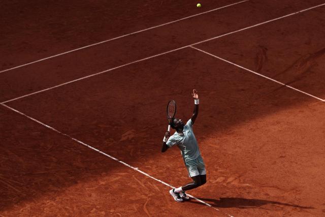 France's Moise Kouame serves to Chile's Alejandro Tabilo during their men's singles match on day 7 of the French Open tennis tournament on Court Suzanne-Lenglen at the Roland-Garros Complex in Paris on May 30, 2026. (Photo by Anne-Christine POUJOULAT / AFP)