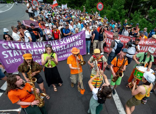 People demonstrate playing music and holding a banner reading: 'Better using rail than to cause traffic chaos' near the A13 Brenner Highway in the direction of Italy during the blockade of the Brenner Base Tunnel and a demonstration against transit traffic on May 30, 2026, on the Tyrolean Brenner Highway. A protest in Austria on May 30 against noise and pollution is set to close one of Europe's most important highways connecting Germany and Italy, potentially causing major traffic disruptions.
Communities in Austria's western Tyrol province have long complained about traffic, especially trucks passing over the Brenner Pass and through the province. (Photo by Joe Klamar / AFP)