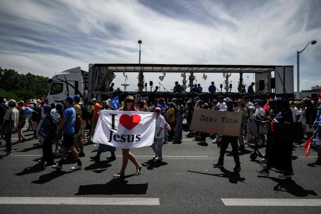 People take part in the "Marche pour Jesus" (March for Jesus) Christian event in Lyon on May 30, 2026. (Photo by Jeff PACHOUD / AFP)
