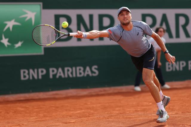 Belgium's Raphael Collignon plays a forehand return to Italy's Matteo Arnaldi during their men's singles match on day 7 of the French Open tennis tournament at the Roland-Garros Complex in Paris on May 30, 2026. (Photo by Thomas SAMSON / AFP)