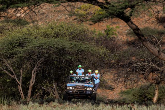 Members of Team Choms navigate their modified Range Rover classic up a wooded hillside as they approach a check point during the Rhino Charge 2026 competition at Ngilai community conservance in Samburu county on May 30, 2026. The Rhino Charge is an annual bush-bashing competition that attracts extreme off-roading enthusiasts who navigate designated sections of uncharted wilderness in specially self-modified vehicles to raise funds for the conservation of Kenya's water towers.Since its inception in 1989, the Rhino Charge has raised over KES 2.6 billion (approximately $20 million USD) that has been used to construct and maintain some 853 kilometres of protective fences around the country's main water catchments that safeguard indigenous forest and certain threatened species residing therein. (Photo by Tony KARUMBA / AFP)