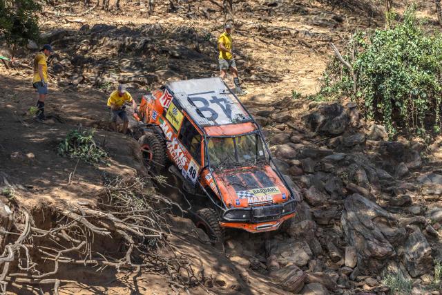 Members of Team 48 Glen  navigate down a steep rocky descent  during the Rhino Charge 2026 competition at Ngilai community conservance in Samburu county on May 30, 2026. The Rhino Charge is an annual bush-bashing competition that attracts extreme off-roading enthusiasts who navigate designated sections of uncharted wilderness in specially self-modified vehicles to raise funds for the conservation of Kenya's water towers.Since its inception in 1989, the Rhino Charge has raised over KES 2.6 billion (approximately $20 million USD) that has been used to construct and maintain some 853 kilometres of protective fences around the country's main water catchments that safeguard indigenous forest and certain threatened species residing therein. (Photo by Tony KARUMBA / AFP)