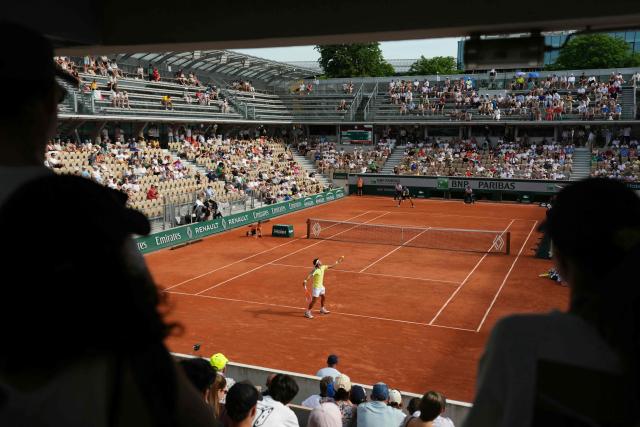 Argentina's Francisco Comesana (front) serves to Italy's Matteo Berrettini during their men's singles match on day 7 of the French Open tennis tournament on Court Simonne-Mathieu at the Roland-Garros Complex in Paris on May 30, 2026. (Photo by Dimitar DILKOFF / AFP)