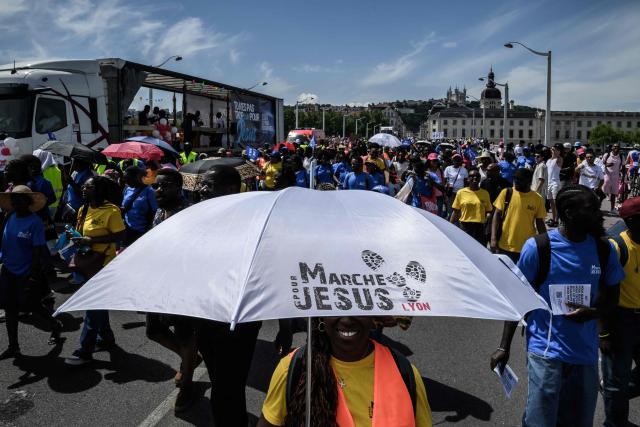 People take part in the "Marche pour Jesus" (March for Jesus) Christian event in Lyon on May 30, 2026. (Photo by Jeff PACHOUD / AFP)