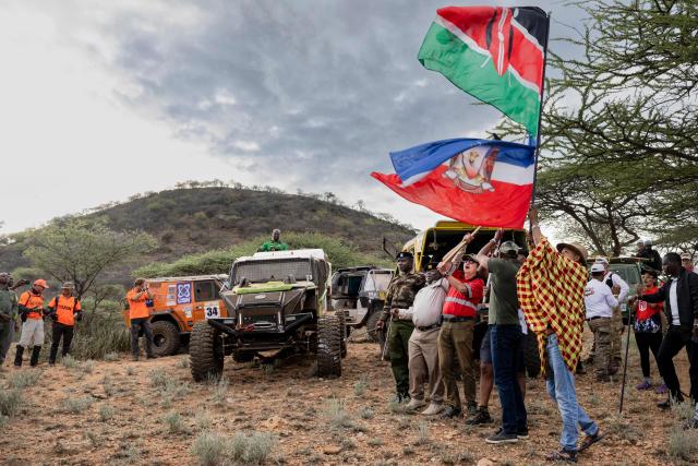 Samburu county officials flag off alongside the Rhino Charge Executive Director, Christian Lambrechts (3R) participating crews at the start of the Rhino Charge 2026 competition at Ngilai community conservancy in Samburu county on May 30, 2026. The Rhino Charge is an annual bush-bashing competition that attracts extreme off-roading enthusiasts who navigate designated sections of uncharted wilderness in specially self-modified vehicles to raise funds for the conservation of Kenya's water towers.Since its inception in 1989, the Rhino Charge has raised over KES 2.6 billion (approximately $20 million USD) that has been used to construct and maintain some 853 kilometres of protective fences around the country's main water catchments that safeguard indigenous forest and certain threatened species residing therein. (Photo by Tony KARUMBA / AFP)