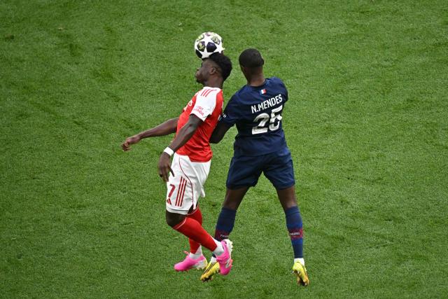Arsenal's English midfielder #07 Bukayo Saka and Paris Saint-Germain's Portuguese defender #25 Nuno Mendes fight for the ball during the UEFA Champions League final football match between Paris Saint-Germain (PSG) and Arsenal FC at the Puskas Arena in Budapest on May 30, 2026. (Photo by Attila KISBENEDEK / AFP)