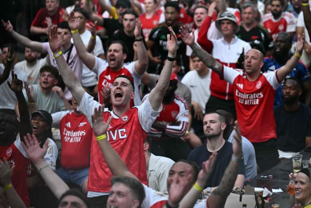 Arsenal fans react as they watch a live broadcast of the UEFA Champions League final football match between Arsenal and Paris Saint-Germain, at Boxpark Wembley in London, on May 30, 2026. (Photo by Ben STANSALL / AFP)