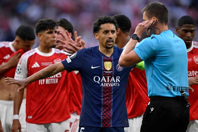 Paris Saint-Germain's Brazilian defender #05 Marquinhos (L) speaks with German referee Daniel Siebert (R) during the UEFA Champions League final football match between Paris Saint-Germain (PSG) and Arsenal FC at the Puskas Arena in Budapest on May 30, 2026. (Photo by INA FASSBENDER / AFP)