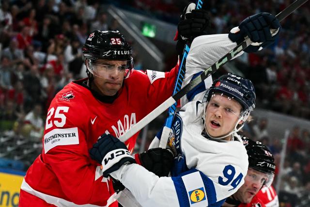 Canada’s defender #25 Darnell Nurse (L) vies Finland's forward #94 Konsta Helenius during the IIHF Ice Hockey Men's World Championship semi-final match between Canada and Finland at the Swiss Life Arena in Zurich, on May 30, 2026. (Photo by Fabrice COFFRINI / AFP)