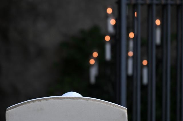 Pope Leo XIV (on armchair from behind) prays at the replica of the Lourdes Grotto in the Vatican's Gardens during the celebration of a rosary event marking the closing of the Marian month, in The Vatican on May 30, 2026. (Photo by TIZIANA FABI / AFP)
