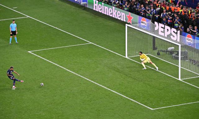 Paris Saint-Germain's French midfielder #14 Desire Doue kicks the ball during the penalty shoot-out in the UEFA Champions League final football match between Paris Saint-Germain (PSG) and Arsenal FC at the Puskas Arena in Budapest on May 30, 2026. (Photo by Attila KISBENEDEK / AFP)