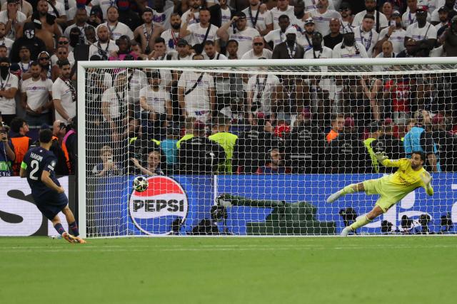 Paris Saint-Germain's Moroccan defender #02 Achraf Hakimi scores from the penalty spot during the UEFA Champions League final football match between Paris Saint-Germain (PSG) and Arsenal FC at the Puskas Arena in Budapest on May 30, 2026. (Photo by Odd ANDERSEN / AFP)