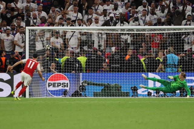 Arsenal's Brazilian midfielder #11 Gabriel Martinelli scores from the penalty spot during the UEFA Champions League final football match between Paris Saint-Germain (PSG) and Arsenal FC at the Puskas Arena in Budapest on May 30, 2026. (Photo by Odd ANDERSEN / AFP)