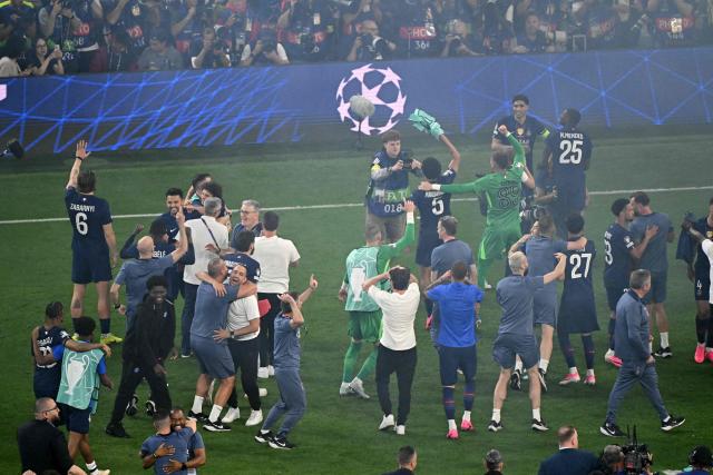 Paris Saint-Germain players celebrate after winning the UEFA Champions League final football match between Paris Saint-Germain (PSG) and Arsenal FC at the Puskas Arena in Budapest on May 30, 2026. (Photo by Attila KISBENEDEK / AFP)