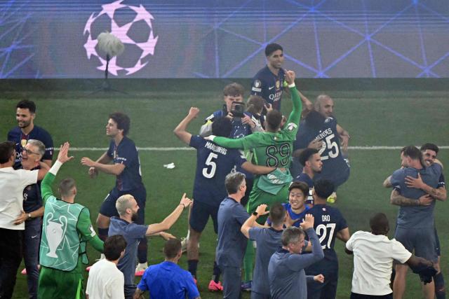 Paris Saint-Germain players and team members celebrate after winning the UEFA Champions League final football match between Paris Saint-Germain (PSG) and Arsenal FC at the Puskas Arena in Budapest on May 30, 2026. (Photo by Attila KISBENEDEK / AFP)