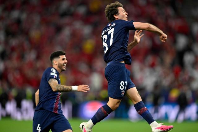Paris Saint-Germain's Portuguese midfielder #87 Joao Neves (R) and Paris Saint-Germain's Brazilian defender #04 Lucas Beraldo celebrate after winning the UEFA Champions League final football match between Paris Saint-Germain (PSG) and Arsenal FC at the Puskas Arena in Budapest on May 30, 2026. (Photo by INA FASSBENDER / AFP)