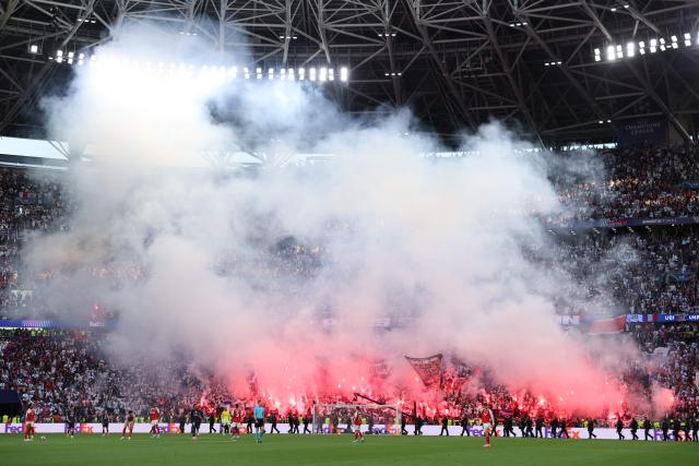 Fans hold lit flares after the UEFA Champions League final football match between Paris Saint-Germain (PSG) and Arsenal FC at the Puskas Arena in Budapest on May 30, 2026. (Photo by Odd ANDERSEN / AFP)