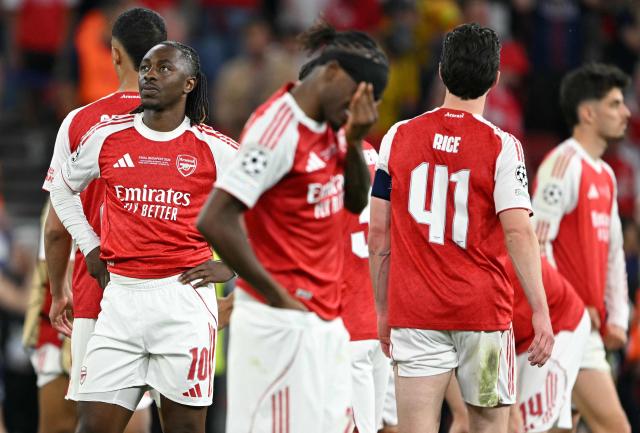 Arsenal's English midfielder #10 Eberechi Eze (L) and teammates react after the UEFA Champions League final football match between Paris Saint-Germain (PSG) and Arsenal FC at the Puskas Arena in Budapest on May 30, 2026. Paris Saint-Germain beat Arsenal 4-3 on penalties to win their second consecutive Champions League title after a 1-1 draw in the final in Budapest on May 30. (Photo by NICOLAS TUCAT / AFP)