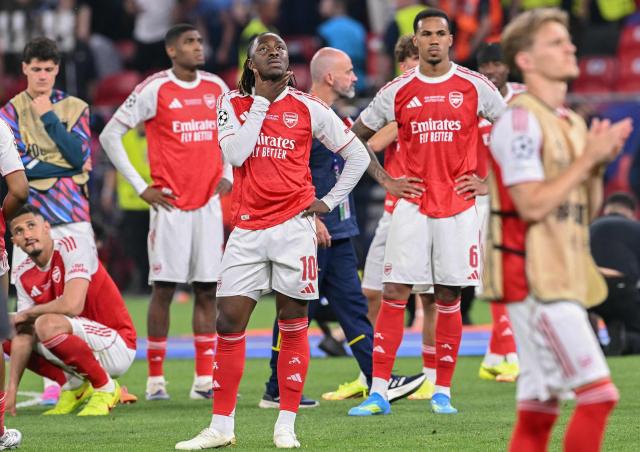 Arsenal's English midfielder #10 Eberechi Eze (C-L) and teammates react after the UEFA Champions League final football match between Paris Saint-Germain (PSG) and Arsenal FC at the Puskas Arena in Budapest on May 30, 2026. Paris Saint-Germain beat Arsenal 4-3 on penalties to win their second consecutive Champions League title after a 1-1 draw in the final in Budapest on May 30. (Photo by NICOLAS TUCAT / AFP)