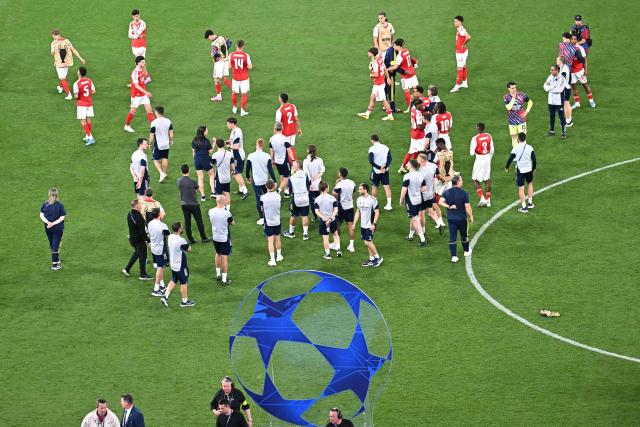 Arsenal players and team members react after loosing the UEFA Champions League final football match between Paris Saint-Germain (PSG) and Arsenal FC at the Puskas Arena in Budapest on May 30, 2026. (Photo by Attila KISBENEDEK / AFP)